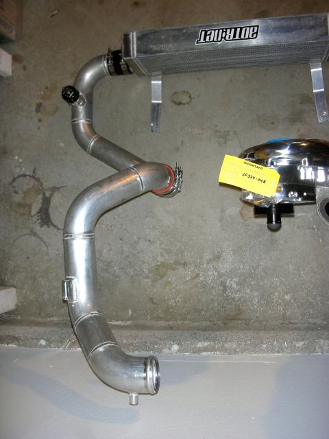 2004 Ford Crown Victoria - Aftermarket intercooler piping and air filter assembly, likely for a performance vehicle modification.