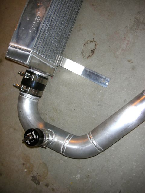 2004 Ford Crown Victoria - Close-up of an aftermarket supercharger component, likely an intercooler and piping.
