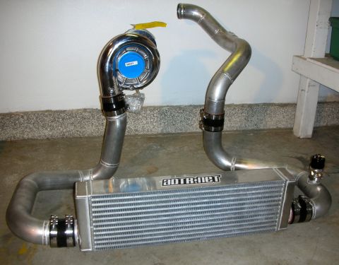 2004 Ford Crown Victoria - A turbocharger and intercooler system, labeled ADTR.NET, is displayed on a concrete floor.