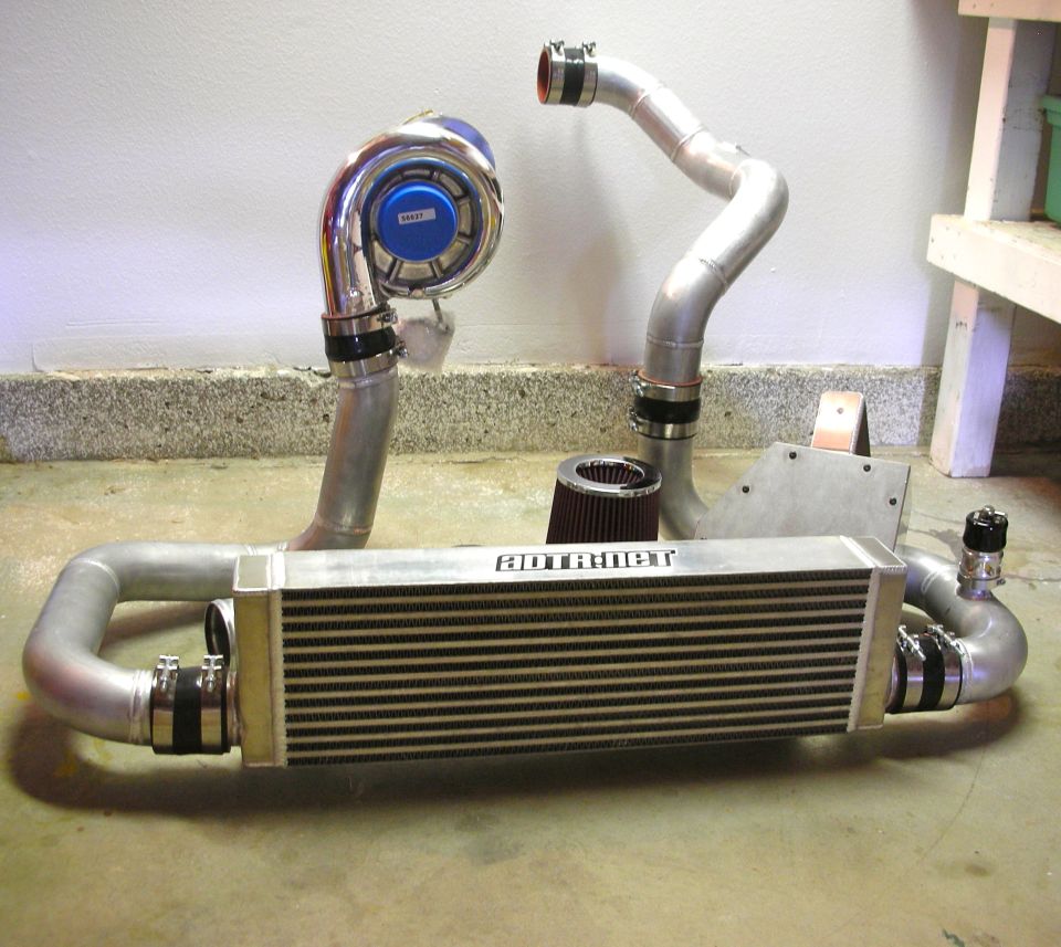 Supercharger, intercooler, and air filter for a vehicle engine