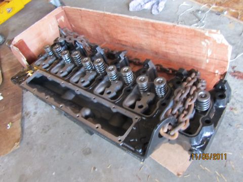 1984 Ford Bronco - A disassembled engine cylinder head, valves and springs, is shown resting in a wooden crate.