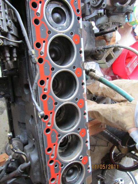 1984 Ford Bronco - Close-up of a vehicle's engine cylinder head gasket, showing the six circular openings for the cylinders.
