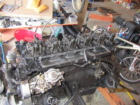 1984 Ford Bronco - Engine block and fuel injection pump assembly in a workshop setting. Date stamp visible.