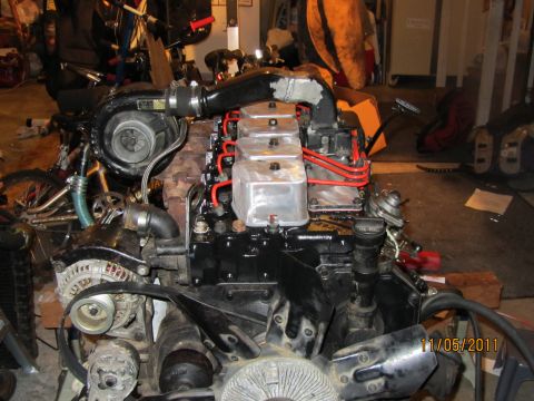 1984 Ford Bronco - Engine assembly with turbocharger and fuel system components visible.