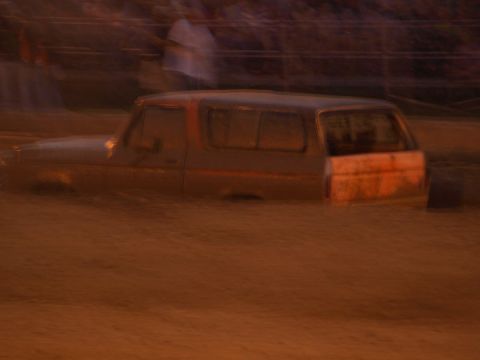 1978 Ford Bronco - A Ford Bronco is partially submerged in mud, with only the upper portion of the vehicle visible.
