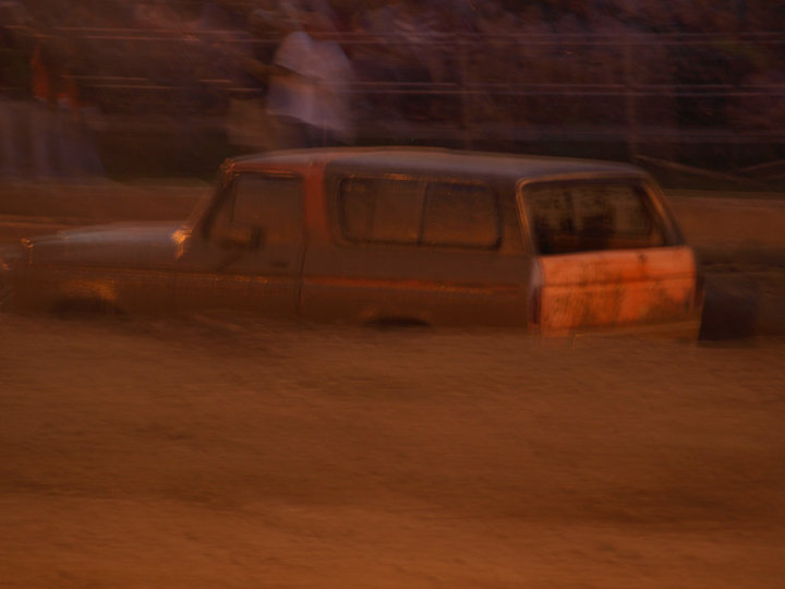 Ford Bronco stuck in mud, side view. Mud is up to the windows