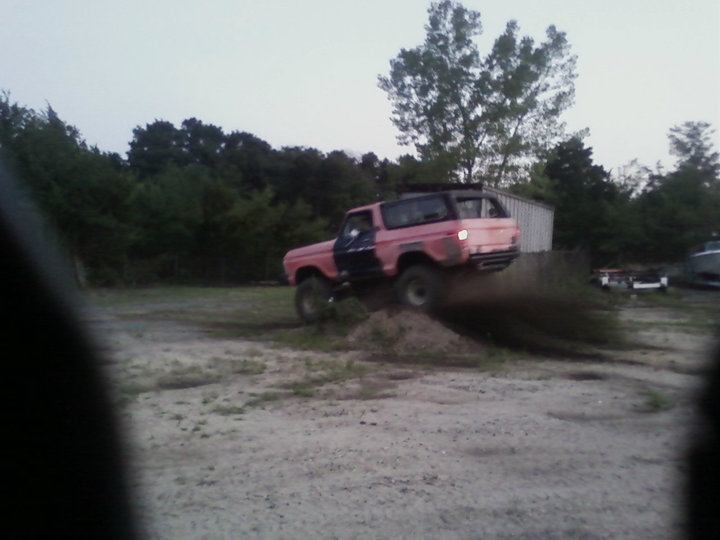 1978 Ford Bronco driving off-road, kicking up dirt