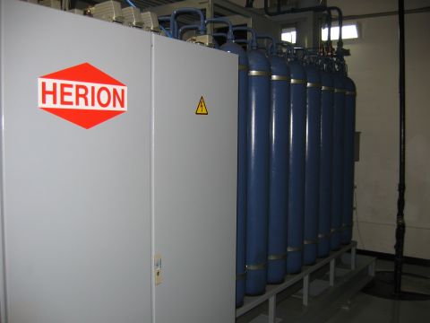 1971 Ford Ranchero - A row of blue industrial cylinders stands next to a gray cabinet bearing the HERION logo and a warning triangle.