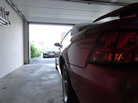 2003 Mercury Marauder - Two cars in a garage, one red sports car and a black Audi sedan.