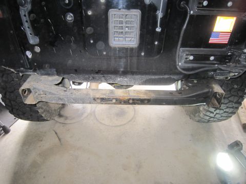 2008 Jeep Wrangler - Underbody view of a Jeep Wrangler, focusing on the rear crossmember and tire.