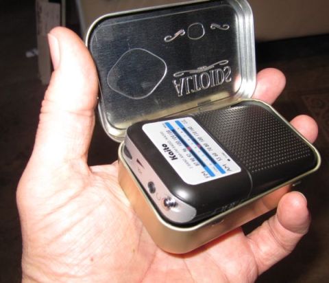 1990 Ford Bronco - A Kaito pocket radio is shown inside a tin, with tuning bands visible.