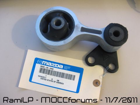1989 Mazda MX-6 - A Mazda engine mount part is shown with its part number and manufacturing details on a tag.