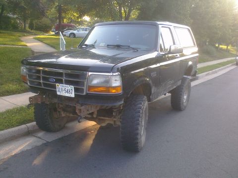 1995 Ford Bronco - This 1995 Ford Bronco features a lifted suspension and is parked on a residential street.