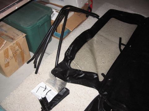 1995 Ford Bronco - Soft top frame and fabric laid out on the floor with assembly instructions nearby.