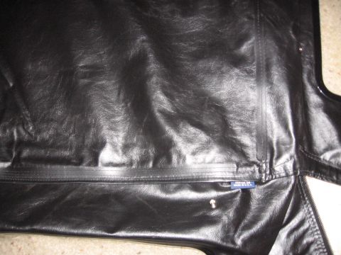 1995 Ford Bronco - A black vinyl soft top is shown with a zipper and a small blue tag indicating its country of origin.