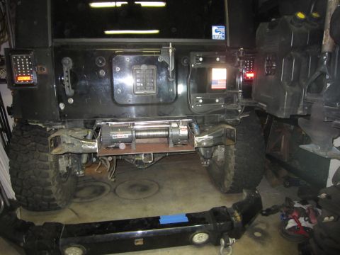 2008 Jeep Wrangler - A black 2008 Jeep Wrangler is shown with a rear winch installed, and a detached bumper in the foreground.