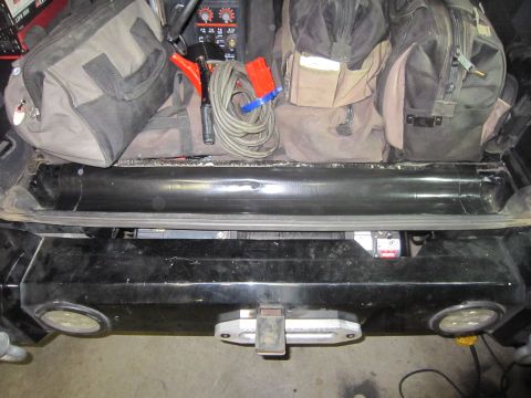 2008 Jeep Wrangler - The rear of a vehicle shows a winch and tow hitch, with several cargo bags stored above.