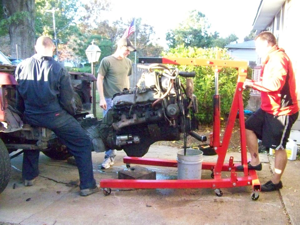 Engine being lifted out of a vehicle with an engine hoist