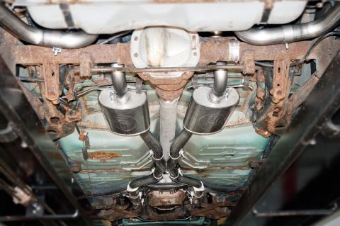 1998 Ford Crown Victoria - Undercarriage view of a vehicle's dual exhaust system, including mufflers with an 'SW' logo visible.