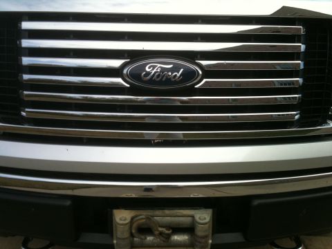 1995 Ford Bronco - The grille design indicates a Ford F-150 from the 2009-2014 model years, not a 1995 Bronco.