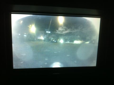 2007 Subaru Impreza - Nighttime view from a backup camera displays a parking lot with illuminated streetlights and other vehicles.