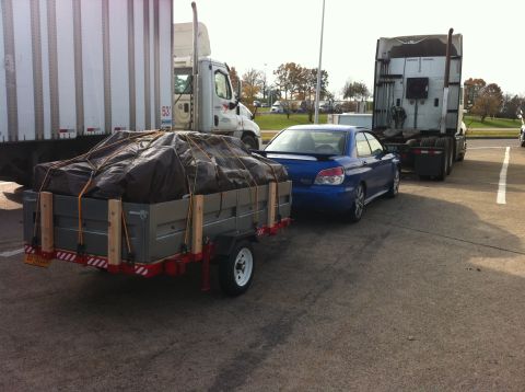 2007 Subaru Impreza - A blue Subaru Impreza WRX hatchback is seen from the rear 3/4 angle, towing a trailer.