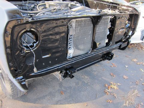1987 Dodge 1500 - The front clip of a truck is disassembled, showing the radiator and engine bay components during a repair or restoration process.