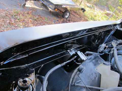 1987 Dodge 1500 - Close-up view of a vehicle's engine bay, showing painted surfaces and various components.