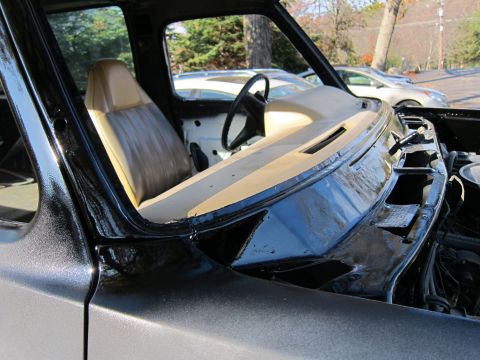 1987 Dodge 1500 - The interior of a truck shows tan seats and a black dashboard, with a steering wheel visible.