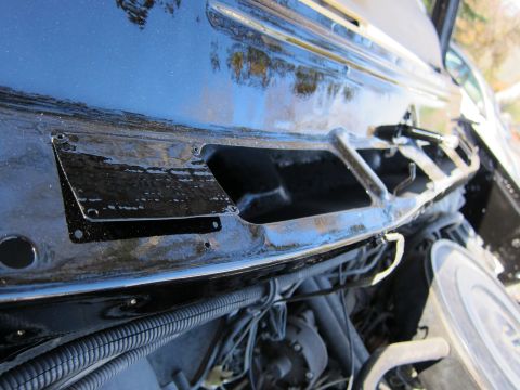 1987 Dodge 1500 - Close-up view of the black windshield wiper cowl area, revealing exposed engine components and wiring beneath.