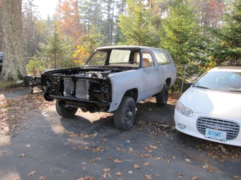 1987 Dodge 1500 - This 1987 Dodge Ramcharger is undergoing bodywork, with its engine bay exposed and ready for restoration.
