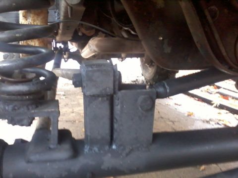 1986 Ford Bronco - Undercarriage view of suspension components, with a SUPERMOTORS.NET watermark.