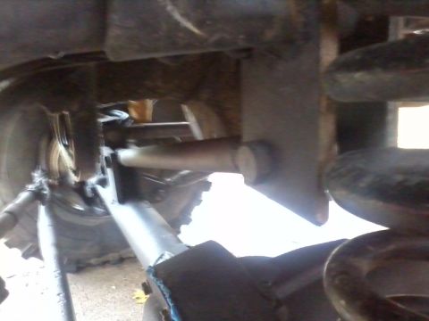 1986 Ford Bronco - This photo shows the undercarriage of a vehicle, focusing on the suspension and drivetrain components.