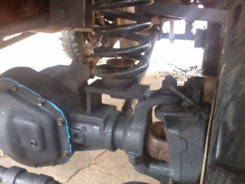 1986 Ford Bronco - Undercarriage view of a vehicle's suspension and differential components.