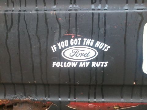 1986 Ford Bronco - A sticker on a vehicle reads 'IF YOU GOT THE NUTS FOLLOW MY RUTS' with a Ford emblem.