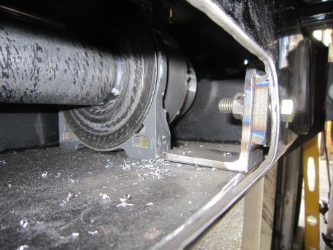 2008 Jeep Wrangler - Close-up of a winch drum and its mounting bracket, showing metal shavings on the surface.