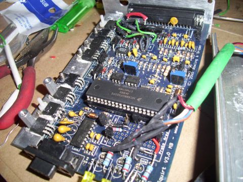 1995 Ford Probe - This electronic circuit board features a central microcontroller and various other electronic components, with tools nearby.