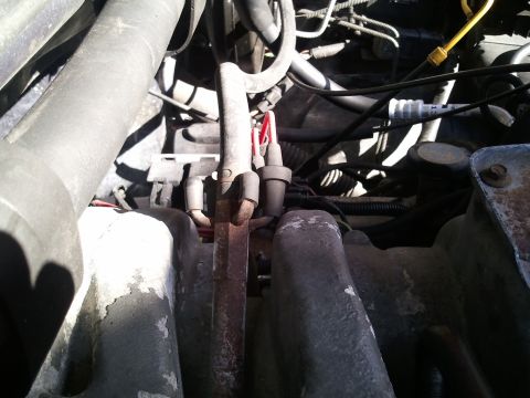 1994 Ford Bronco - Close-up view of AC system components within an engine bay.