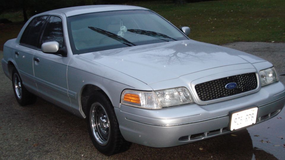 Silver 2000 Ford Crown Victoria parked outside, front quarter view