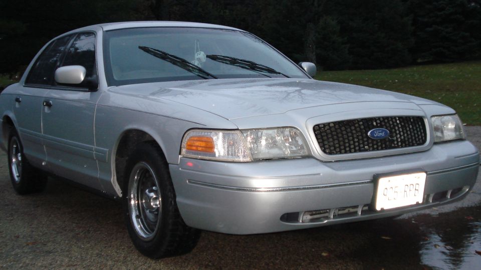Silver 2000 Ford Crown Victoria parked outside