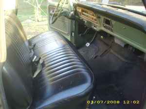 2004 Ford F-150 - Interior view of a classic pickup truck, showing the bench seat and dashboard.