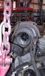 1994 Ford Probe - A close-up view of a turbocharger, with a large pink chain obscuring part of the foreground.