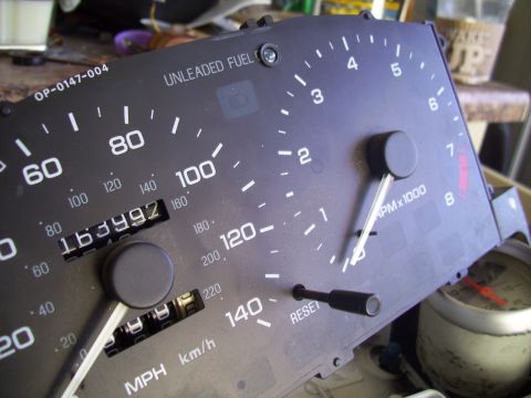 1995 Ford Probe - Close-up of a car's instrument cluster, a speedometer, tachometer, and odometer.