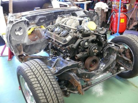 1976 Chevrolet Corvette - The vehicle is undergoing restoration with the engine and chassis exposed.
