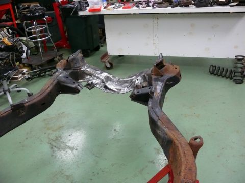 1976 Chevrolet Corvette - This image shows a car frame, possibly from a 1976 Chevrolet Corvette, undergoing repair or restoration.