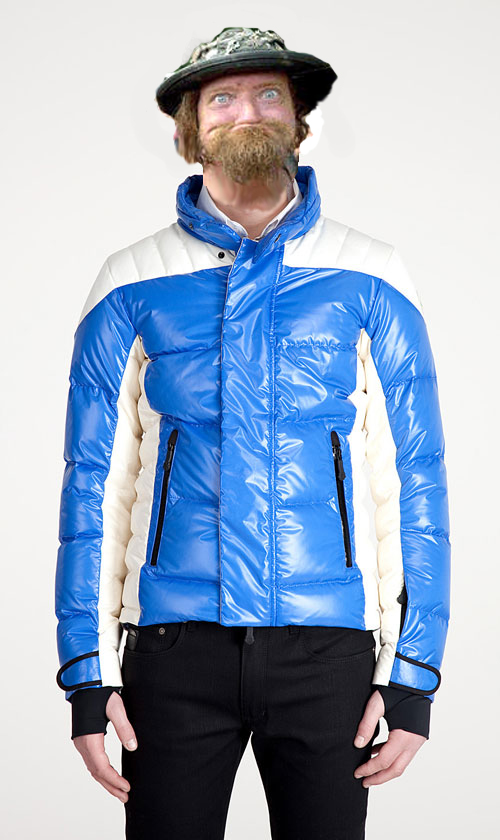 Man wearing a blue and white puffer jacket, black pants, and a camouflage hat with a beard