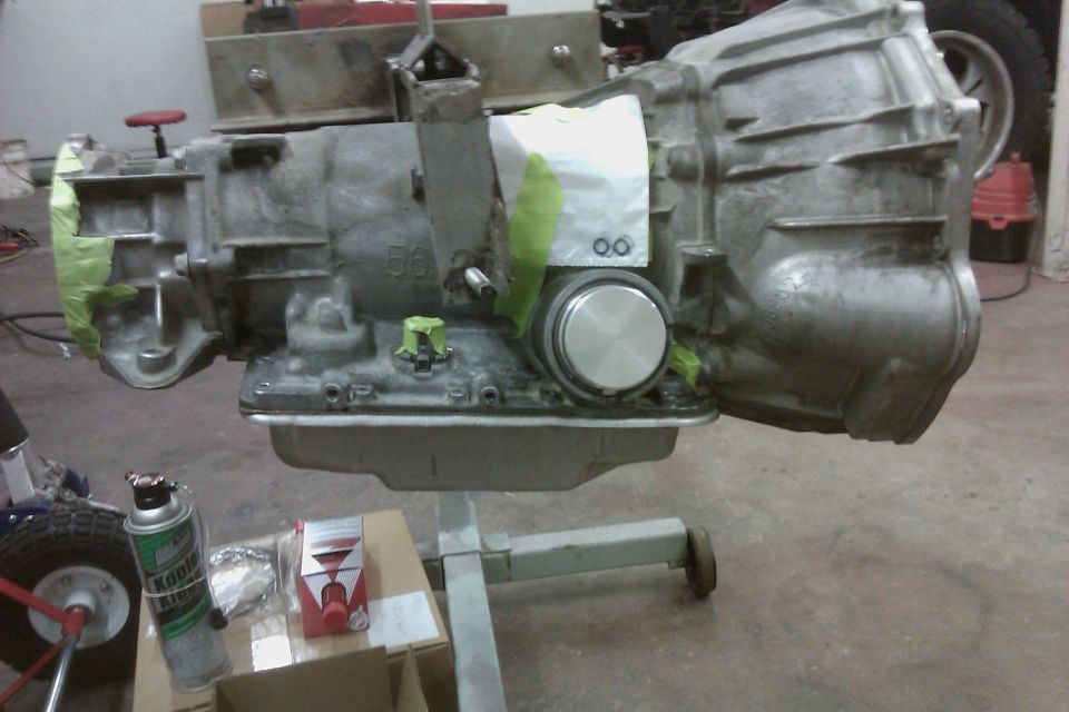 Transmission on stand, partially covered in green tape