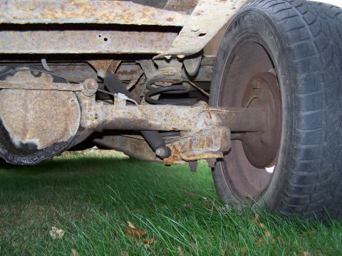 1969 Chevrolet C/K Pickup - This photo shows the rear axle and suspension of a vehicle, with significant rust present on the components.