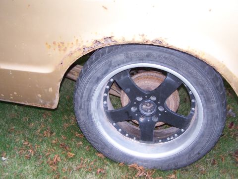 1969 Chevrolet C/K Pickup - The rear wheel well shows significant rust damage, obscuring the vehicle's year.