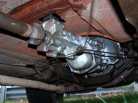 1969 Chevrolet C/K Pickup - Close-up of a vehicle's transmission and driveshaft, showing mechanical components.